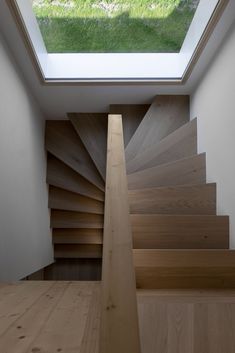 the stairs are made of wood and have skylights above them to let light into the room