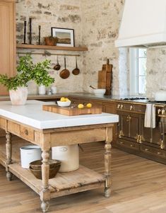 a kitchen with an island in the middle and wooden cabinets on both sides, surrounded by wood flooring