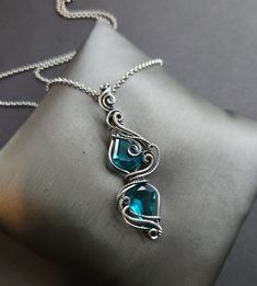 "Handmade wire wrap necklace paraiba blue quartz gemstones, faceted, unique shape  sterling silver wire wrap, oxidized for an antiqued finish, tumbled and hand polished  2 3/4\" pendant length  24\" antiqued silver rolo chain, message me if a different size is needed  comes nicely packaged with a business card, jewelry care instructions and a polishing cloth" Wire Wrapped Faceted Gemstones, Wire Wrapped Stone Jewelry, Card Jewelry, Blue Crystal Necklace, Quartz Gemstones, Wire Wrap Pendant, Sterling Silver Wire Wrap, Jewelry Care Instructions, Wire Pendant