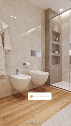 a bathroom with two white sinks sitting next to each other in front of a shower