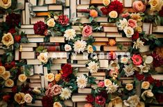 an arrangement of books with flowers on them