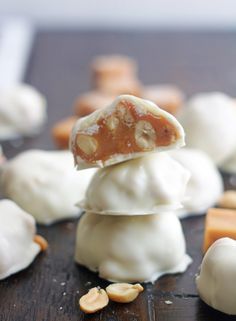 some kind of food that is on top of a wooden table with nuts and candy