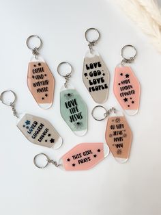 six key chains with different sayings on them