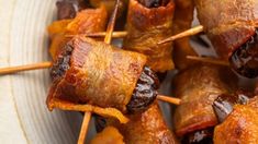 skewers of meat wrapped in bacon on a plate