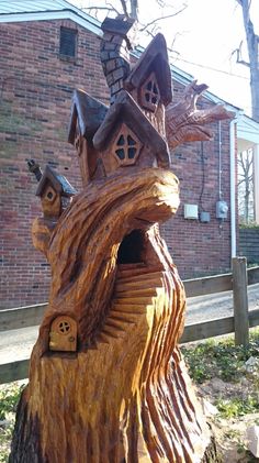 a tree stump with a house built into it