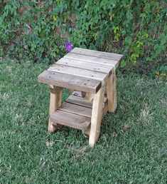 a small wooden table sitting in the grass