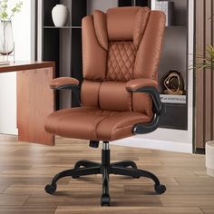 a brown office chair sitting on top of a hard wood floor next to a book shelf