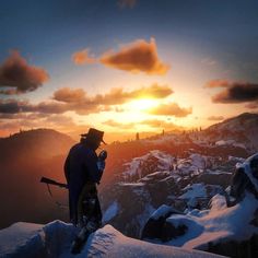 a man standing on top of a snow covered mountain