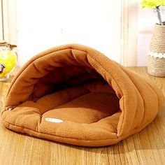 a brown dog bed sitting on top of a wooden table