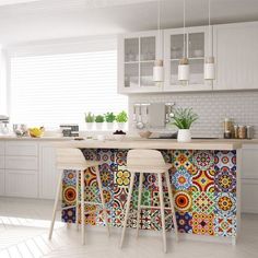 two stools are in front of a colorful tile counter