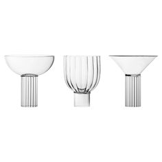 three glass vases and one bowl on a white background