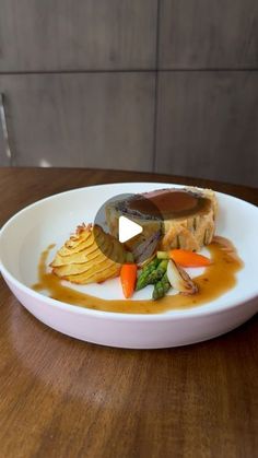 a white plate topped with food on top of a wooden table