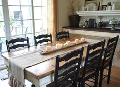 a dining room table with candles on it