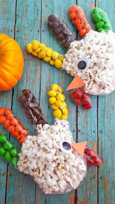 some kind of fake chicken made out of rice and candy corn on a blue wooden table