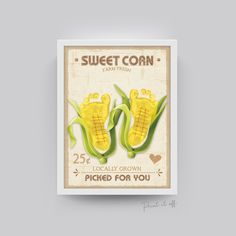 two corn cobs with the words sweet corn on them are placed in front of a gray background