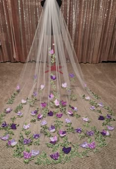 a wedding veil with purple flowers on it