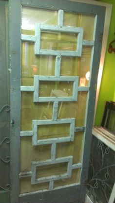 the door is made out of wood and has metal bars on each side, along with glass panels