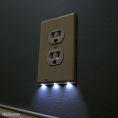 an electrical outlet with two lights on it