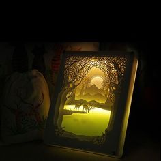 an illuminated photo frame sitting on top of a table