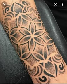 a person with a tattoo on their arm that has an intricate design in the middle