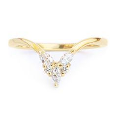 a yellow gold ring with three diamonds on top and two smaller white stones in the middle