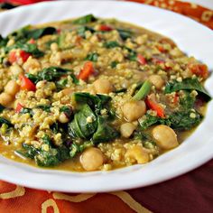 a white plate topped with beans and spinach