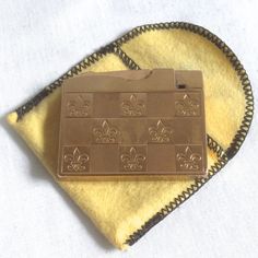 a gold plate with fleur de lis on it sitting on a yellow towel