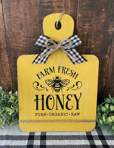 a wooden sign that says farm fresh honey with a bow on the front and side