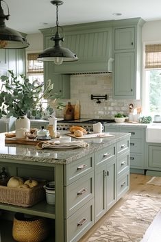 a large kitchen with green cabinets and marble counter tops, an island in the middle