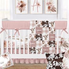 a baby crib bedding set with pink and brown floral prints on the wall