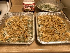 two pans filled with food sitting on top of a counter