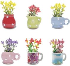 four mugs with flowers in them on a white background and one has polka dots