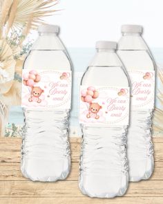 three water bottles with pink teddy bears on them