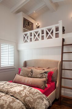 a bed sitting under a window next to a wooden ladder