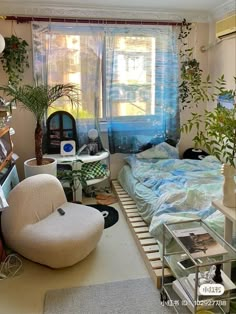 a bedroom with a bed, desk and chair in it's corner area next to a window