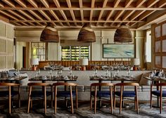 an empty restaurant with tables and chairs in the center, surrounded by wood paneling