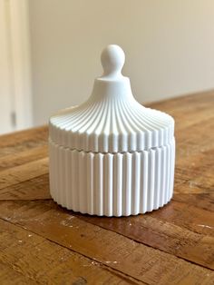 a white container sitting on top of a wooden table