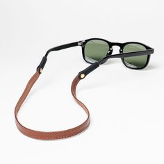 The Original Leather Sunglass Strap by Sounder Goods in our Slim Montauk style. Made with full-grain vegetable tanned leather. Hand stitched, dyed and buffed edges. Patented brass rivet secured soft rubber connectors. Fits all sunglasses (including Costas & Wayfarers). Safe to get wet. US Patents 11,209,666 & 11,782,292. Montauk Style, Husband Fathers Day Gifts, Sunglass Strap, Eyeglass Strap, Sunglasses Strap, The Other Guys, Heritage Fashion, Monogrammed Leather, Stitching Leather