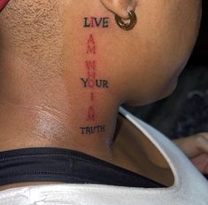 the back of a man's neck with words on it that read live, i am your i am truth