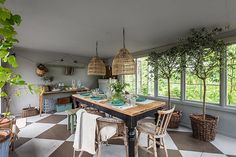 a kitchen with checkered flooring and lots of windows