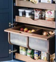 an open pantry door with some food in the bins and other items on it