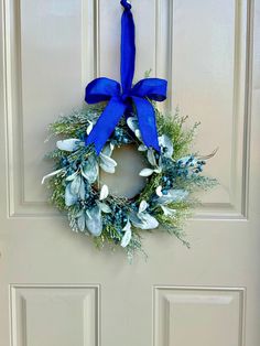 a blue wreath hangs on the front door