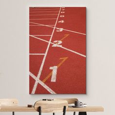 a red track with white numbers on it is in the middle of a dining room