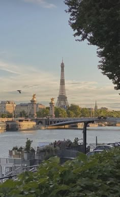 the eiffel tower towering over the city of paris from across the river seine