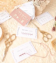 scissors, thread, and other sewing supplies laid out on a lace covered tablecloth