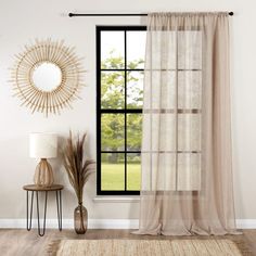 a living room with a large window and a rug on the floor next to it