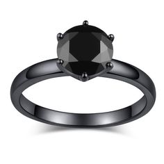 a black diamond engagement ring on a white background with the center stone in the middle