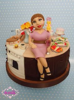 a cake with a woman sitting on top of it