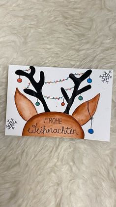 a handmade christmas card with reindeer antlers on it and the words, from santa clausen