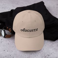 "The Masters is coming soon... make sure you get yourself a hat to support one of the greatest golf tournaments in the world. This classic design comes in various colors to match your outfit on Masters sunday! The design is embroidered into the hat/cap. * 100% chino cotton twill * Green Camo color is 35% chino cotton twill, 65% polyester * Unstructured, 6-panel, low-profile * 6 embroidered eyelets * 3 ⅛\" (7.6 cm) crown * Adjustable strap with antique buckle * Blank product sourced from Vietnam or Bangladesh" Golf Embroidery, Masters Golf Tournament, Masters Tournament, Masters Golf, Golf Hat, Golf Hats, Golf Tournament, Camo Colors, The Masters